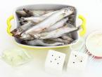 Capelin stewed with onions in a frying pan Cooking capelin in a frying pan